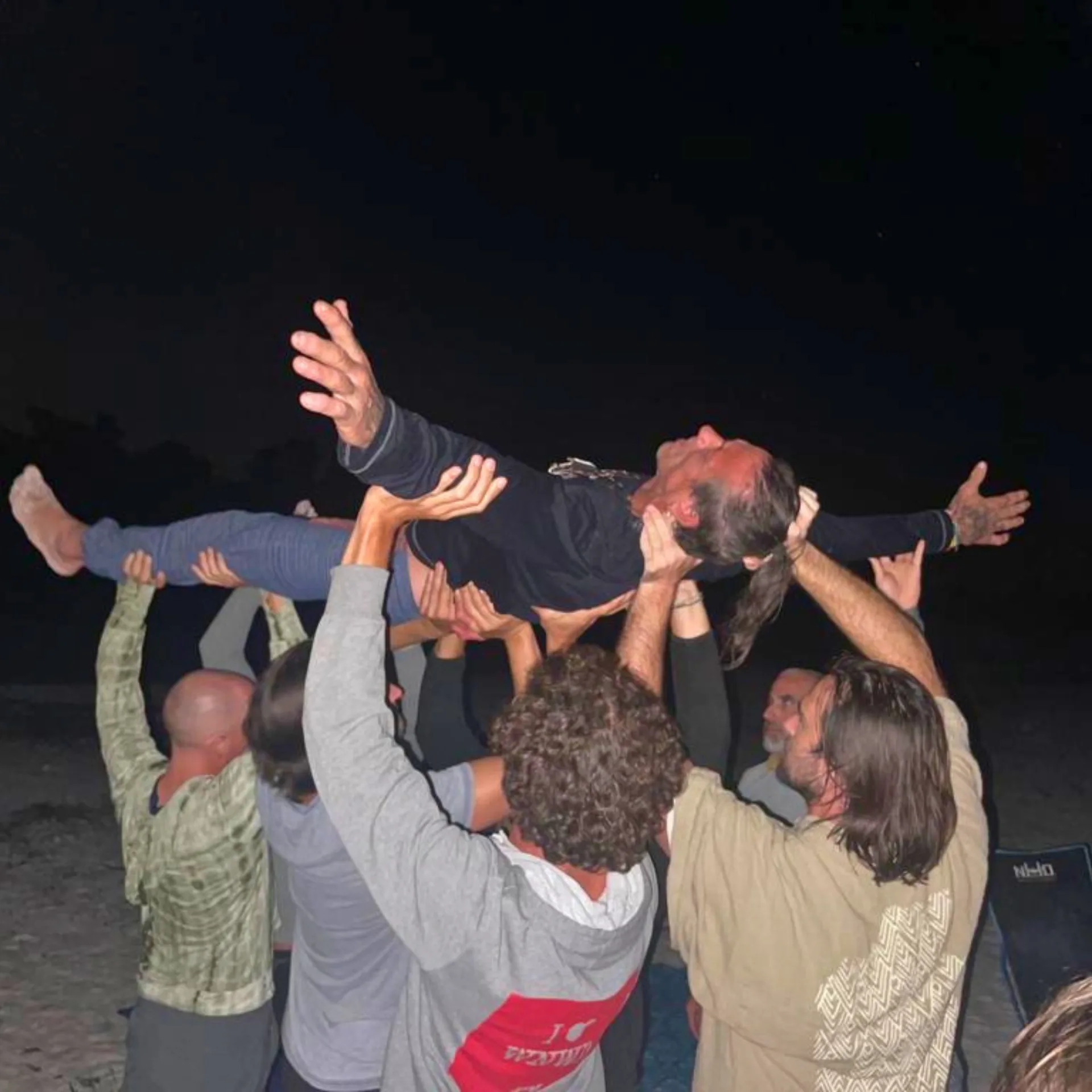 Men lifting each other at a retreat